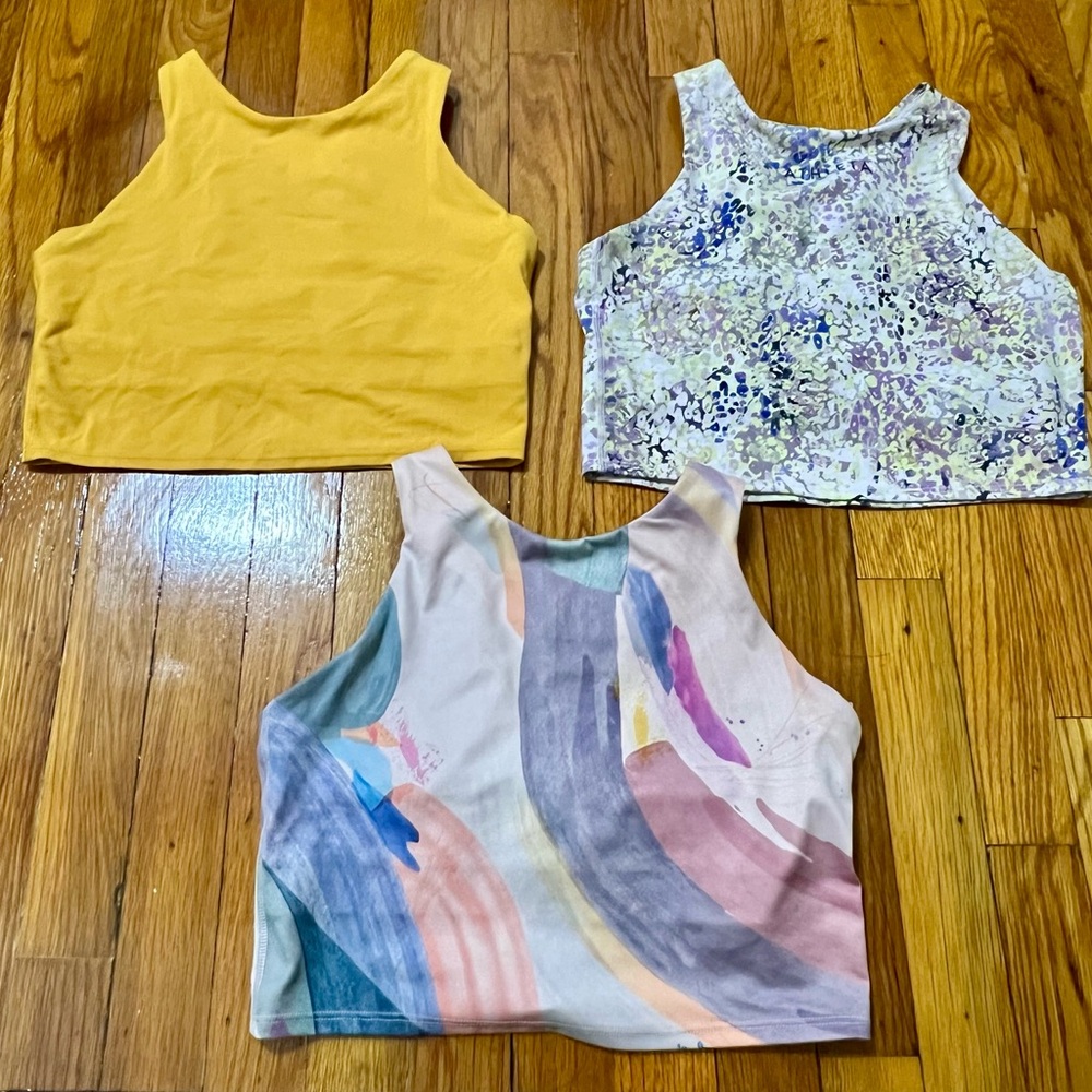 Bundle of three Athleta croptop / long line sports bras. Racerback style.
